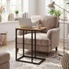 C-shaped end table with a sturdy metal frame and natural wood top, ideal for use beside a chair in a living room.