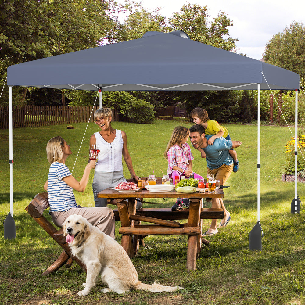 Gray 10x10 ft pop-up canopy tent with sidewall, set up in a backyard for outdoor gatherings and sun protection.