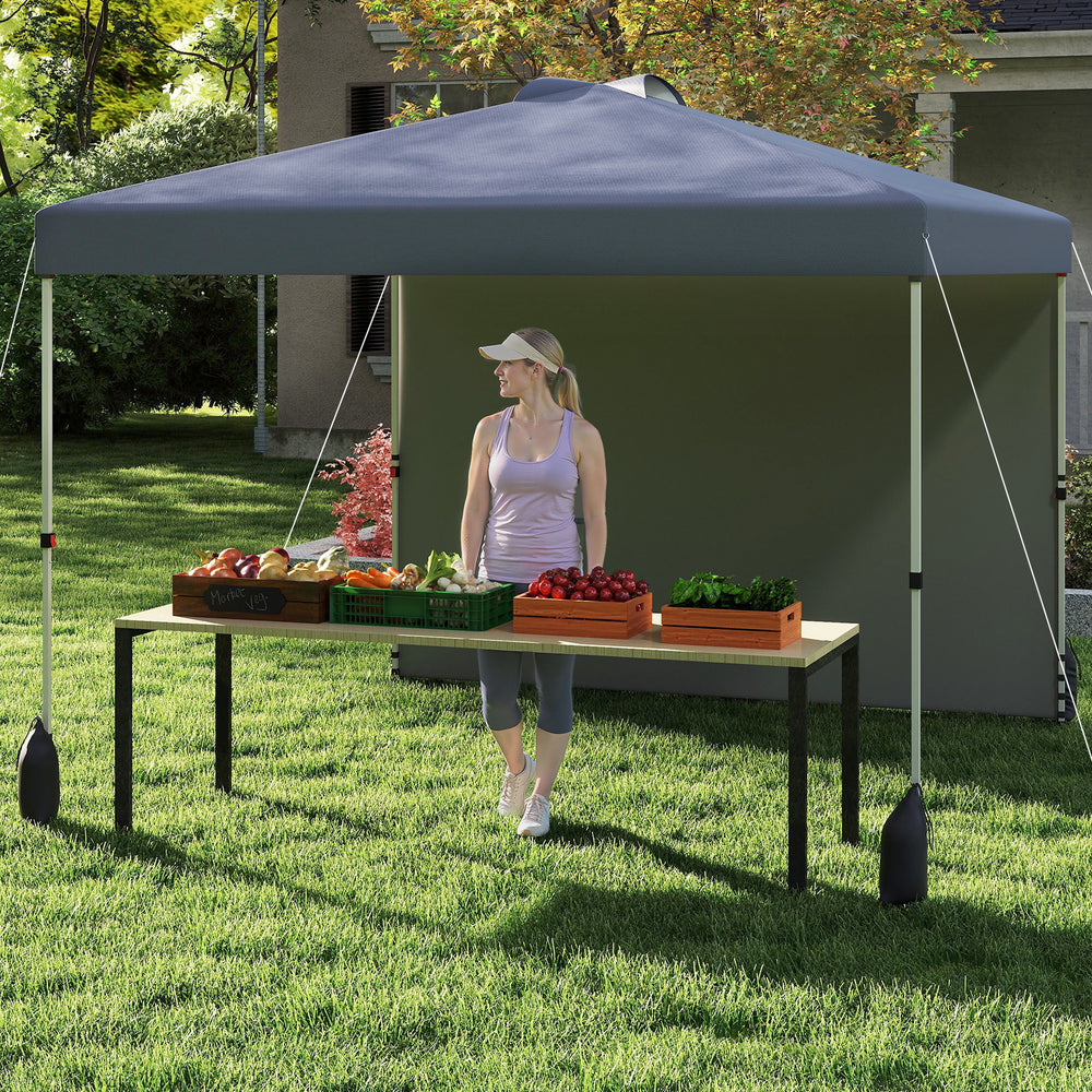 Pop-up canopy tent with sidewall, gray color, set up for outdoor use with fruits on a table for market display.