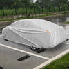 Car cover for 193-inch sedans, waterproof and tear-proof, shown in rainy conditions for ultimate weather protection.