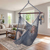 Caribbean hammock chair in gray with metal spreader bar, featuring spacious design and decorative tassels for indoor.