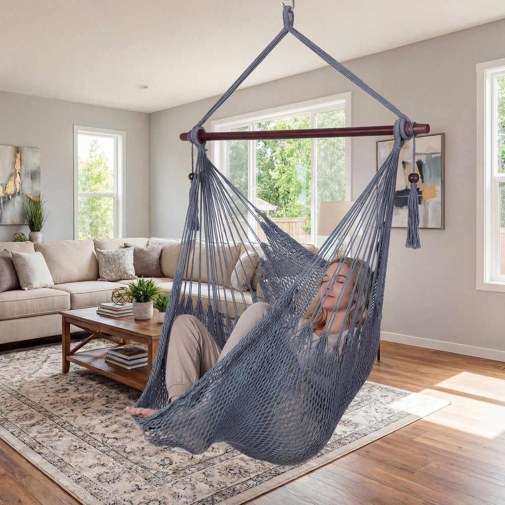 Caribbean hammock chair in gray with metal spreader bar, featuring spacious design and decorative tassels for indoor.