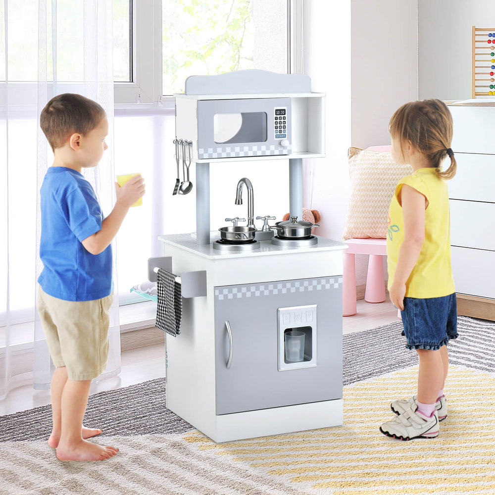 Kids playing with the Chef Pretend Kitchen Playset featuring a stove, sink, and ice dispenser for imaginative fun.