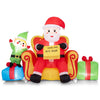 Inflatable Santa Claus with elf and gift boxes on a sofa, designed for cheerful holiday decorating in outdoor spaces.