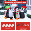 Inflatable Christmas penguin family with LED lights, wearing Santa hats and scarves, perfect for festive outdoor.