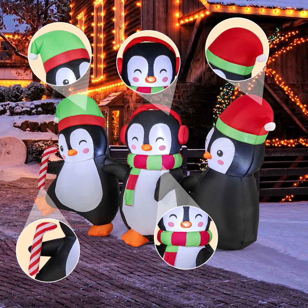 Inflatable Christmas penguins family with LED lights, wearing Santa hats and scarves, perfect for festive outdoor.