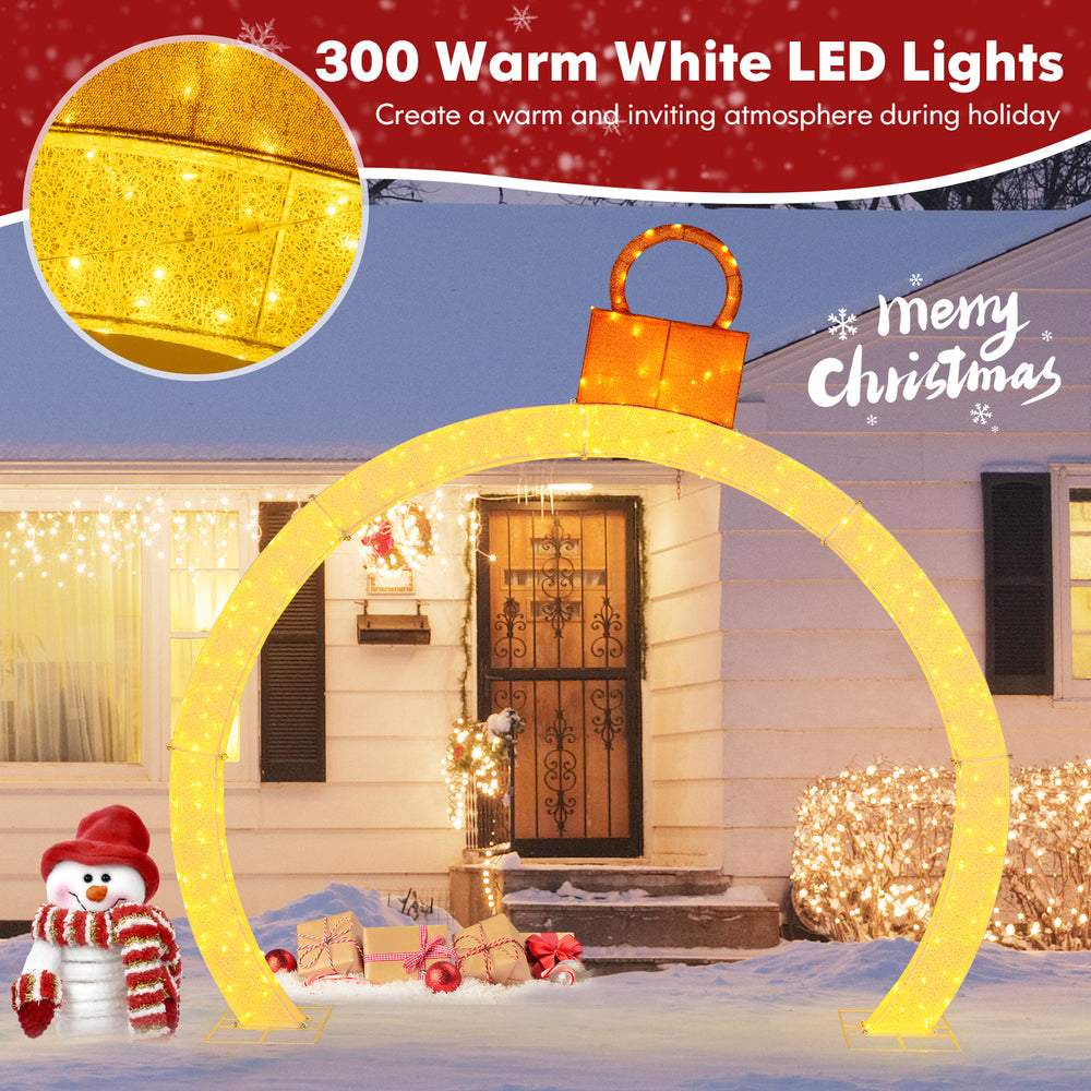 Close-up of the 10.5 feet Christmas pre-lit arch's gold ornament cap and warm white LED lights, ideal for festive decor.