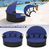 Side view of the Clamshell patio round daybed with retractable blue canopy, showcasing its spacious seating for outdoor.