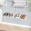 Metal wire shoe racks mounted on the wall, showcasing a stylish arrangement for efficient shoe storage and ventilation.