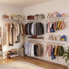 Wall-mounted ventilated metal wire shelving kit with organized clothes, bags, and accessories for efficient closet.