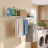 Wall-mounted ventilated metal wire shelving kit with towels and storage bins, ideal for laundry room organization.