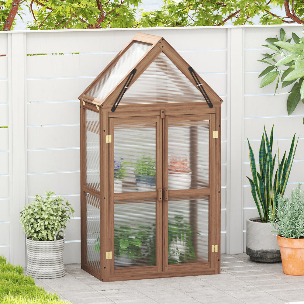 Mini wooden greenhouse with transparent polycarbonate panels, sloping roof, and removable shelves for plant care.