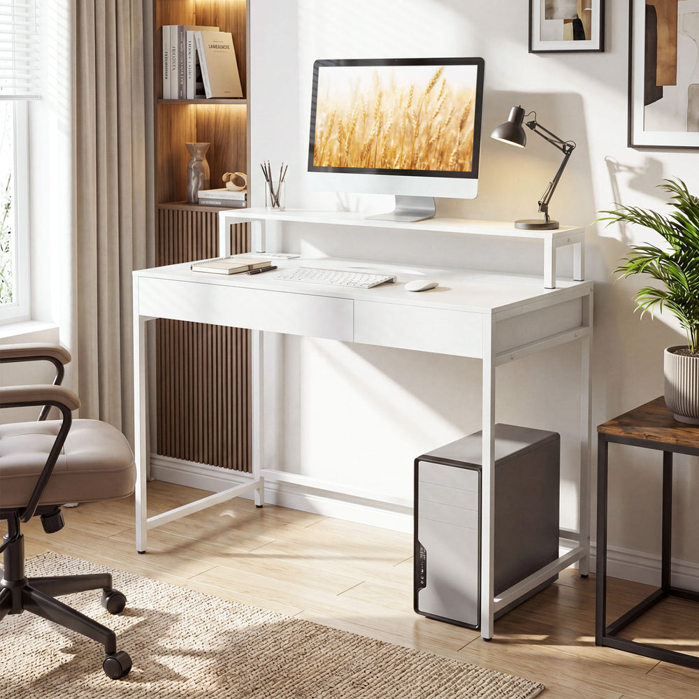 Compact white office desk with removable monitor shelf, dual-use drawer, and ergonomic design for versatile use.