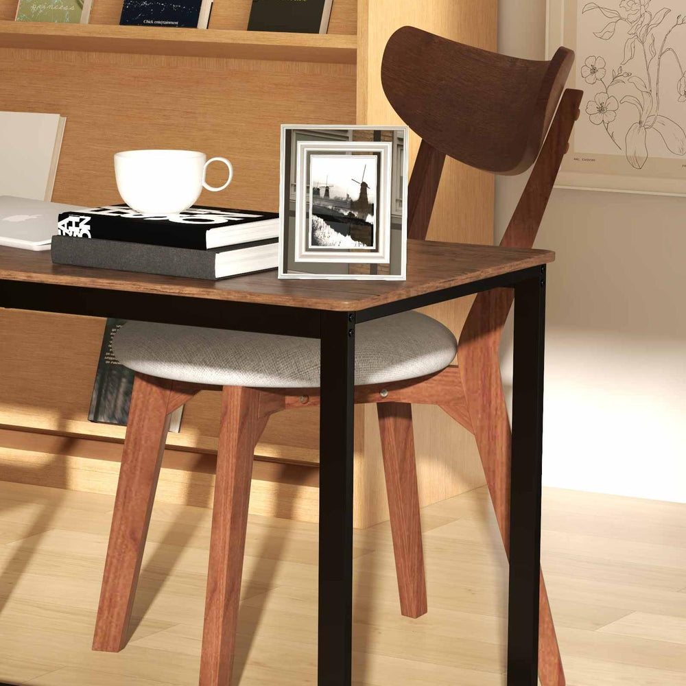 Modern dining chair with ergonomic curved back and wooden legs, paired with a sleek glass table for versatile use.