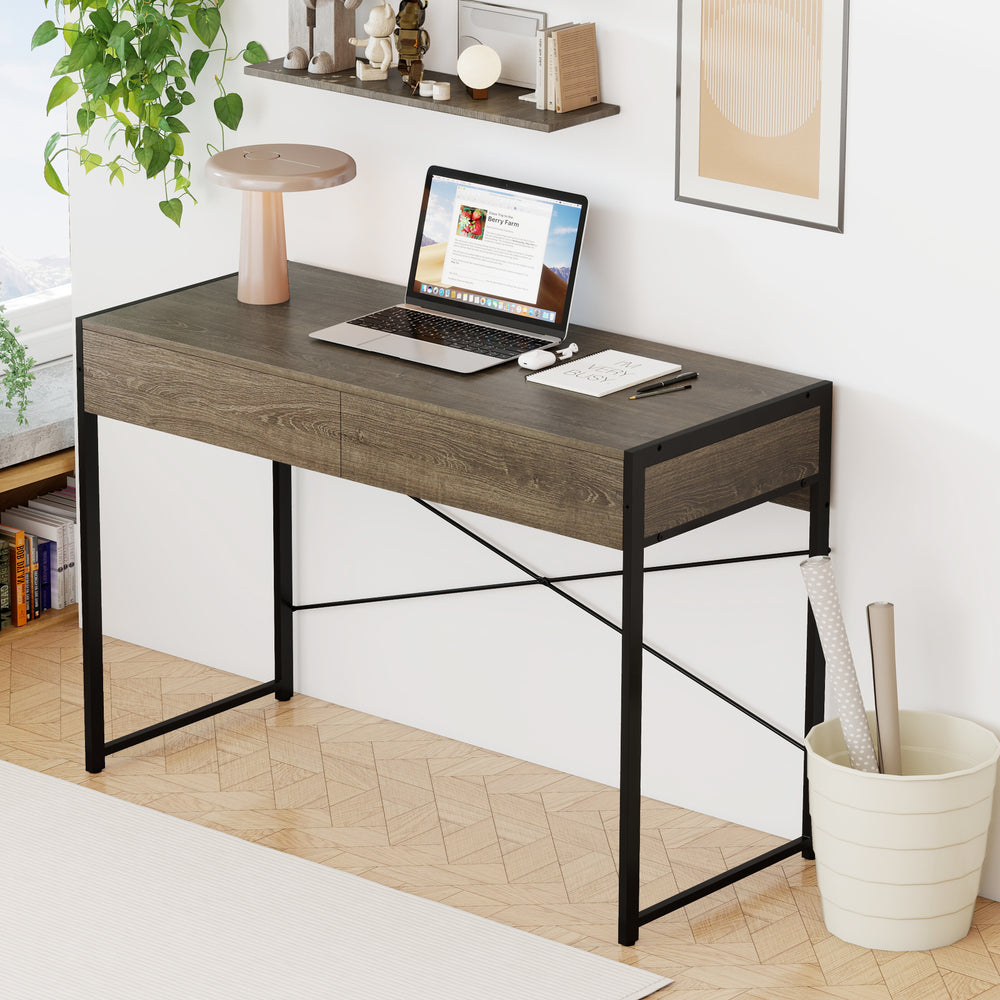 Computer desk with oak finish and metal frame, featuring two drawers for organized storage, ideal for home office use.