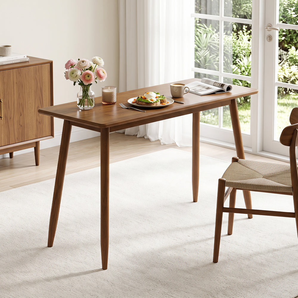 Walnut computer desk with rubber wood legs features a spacious tabletop, ideal for studying, dining, or working.