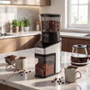 Conical burr coffee grinder in silver, featuring a large bean container, perfect for freshly ground coffee at home.