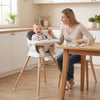 Convertible high chair with solid wood legs, adjustable tray, and comfortable cushion, perfect for feeding babies and.