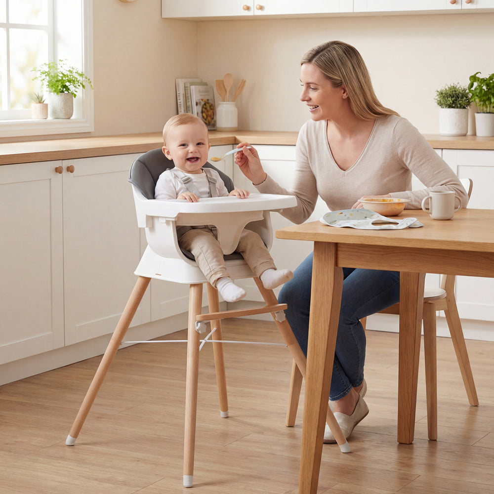 Convertible high chair with solid wood legs, adjustable tray, and comfortable cushion, perfect for feeding babies and.