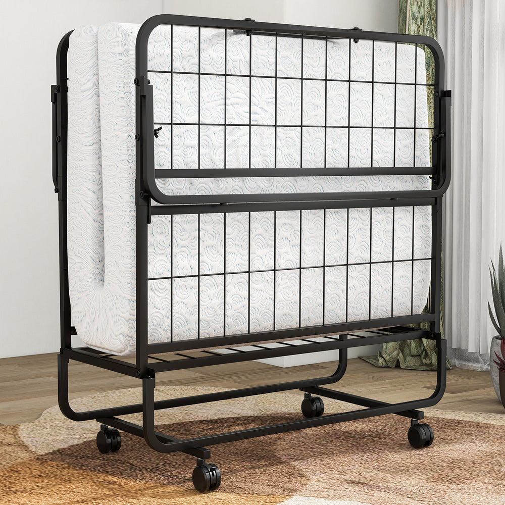Folding bed with memory foam mattress and pillow, featuring a space-saving design and wheels for easy movement.