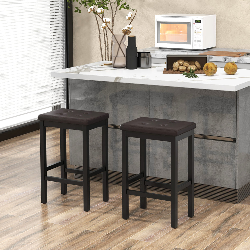 Two 24-inch brown bar stools with padded seats and rubber wood frames, featuring a footrest for comfort and stability.