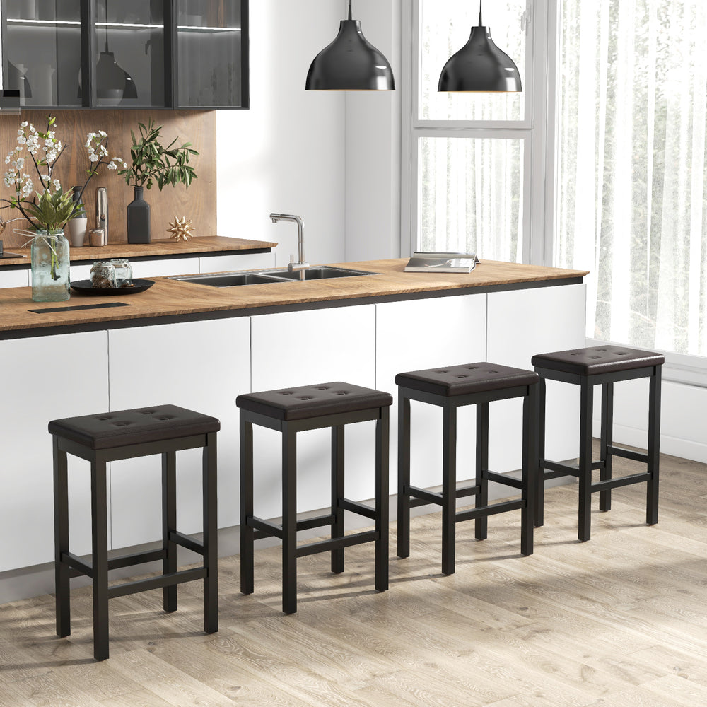 Set of four 24-inch brown bar stools with padded seats and rubber wood frames, ideal for kitchen counter seating.