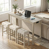 Upholstered stool with tufted design and sturdy rubber wood legs, ideal for under-counter storage in a breakfast nook.