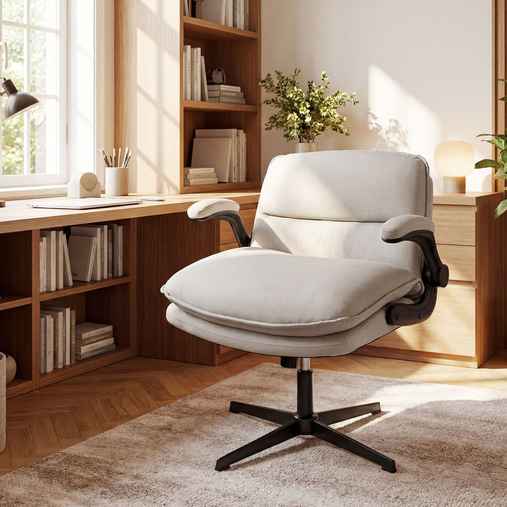 Beige Criss Cross ergonomic office chair with flip-up arms, adjustable height, and wide padded backrest in a bright.