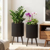 Set of 2 decorative flower pots with modern fluted design, drainage holes, and sturdy metal legs for versatile home decor.