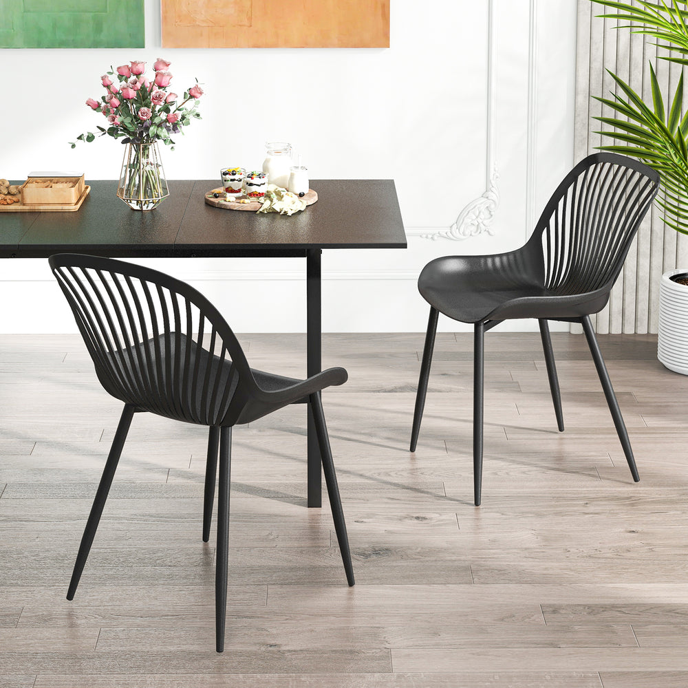 Black modern kitchen chairs with cutout backrest and metal legs, ideal for dining rooms and home offices.