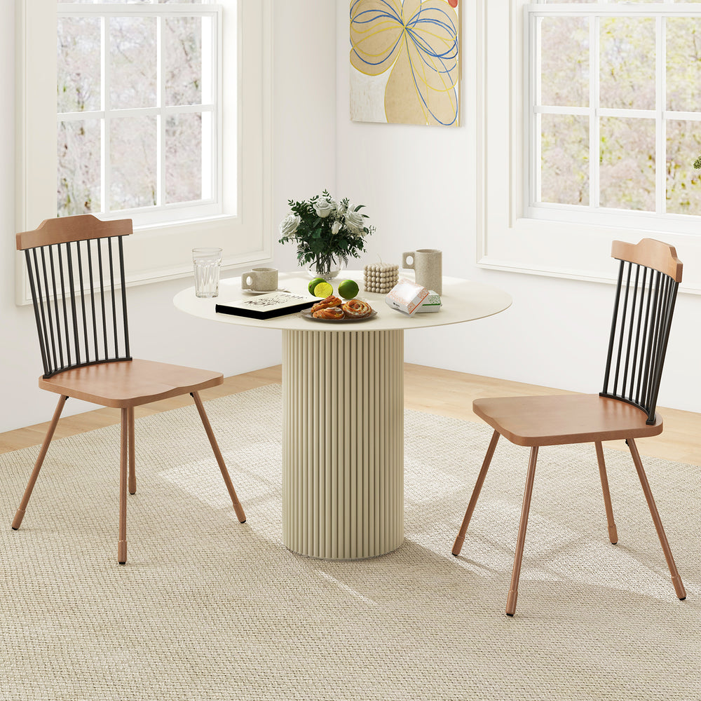 Set of 2 natural dining chairs with spindle back and ergonomic contoured seat, perfect for stylish dining spaces.
