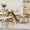Set of 2 natural rubber wood dining chairs with fabric upholstery and spindle backrest for cozy kitchen dining.
