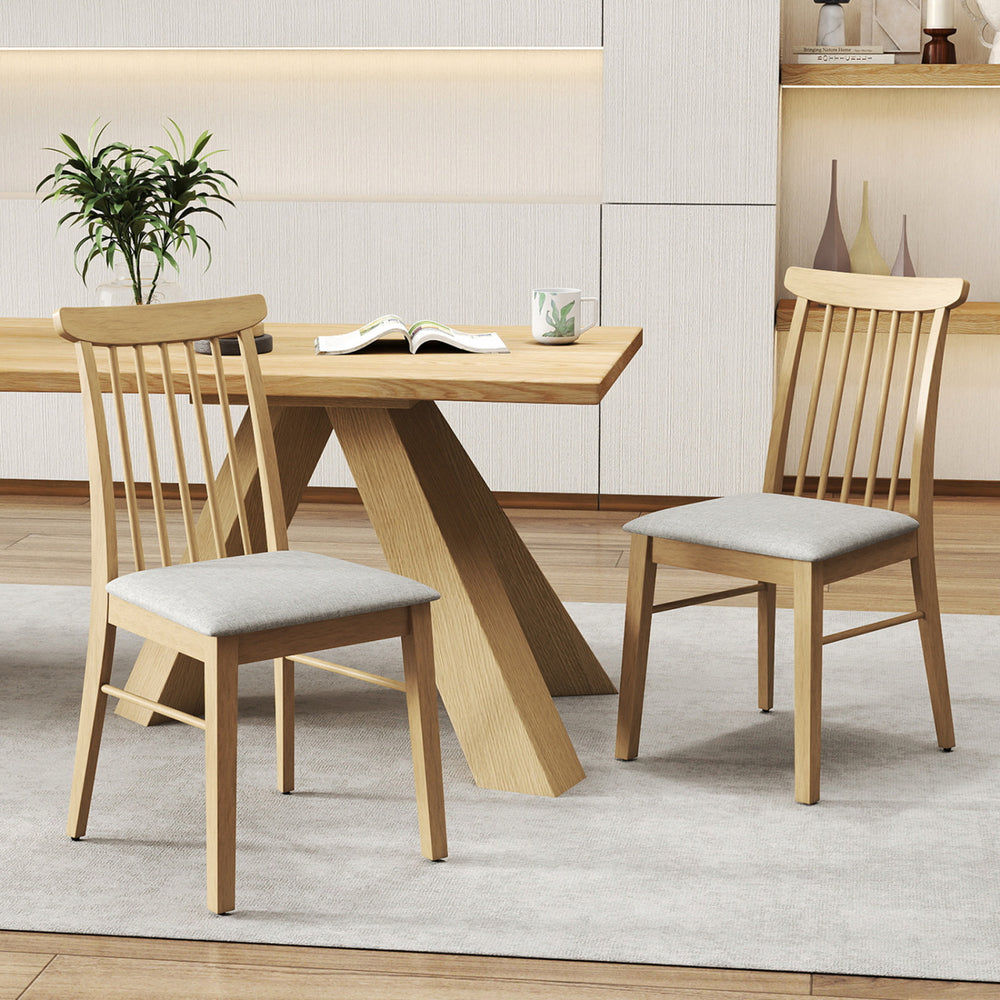 Set of 2 natural rubber wood dining chairs with fabric upholstery and spindle backrest for cozy kitchen dining.