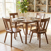 Set of four walnut dining chairs featuring ergonomic backrests and solid rubber wood frames for kitchen or dining room use.
