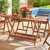 Patio dining table with teak finish, umbrella hole, and spacious design, perfect for backyard or poolside gatherings.