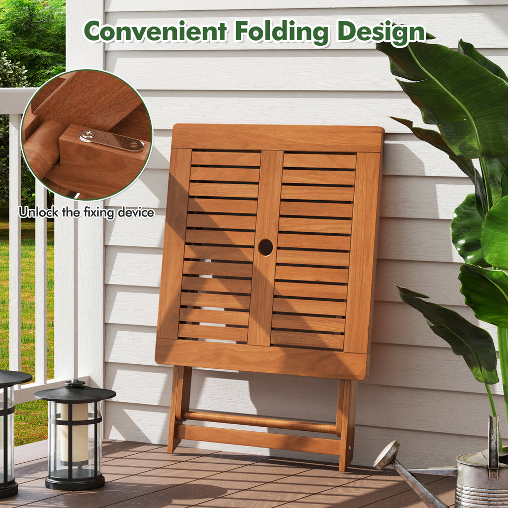 Folding patio dining table with teak finish, umbrella hole, and sturdy X-shaped structure for outdoor use.