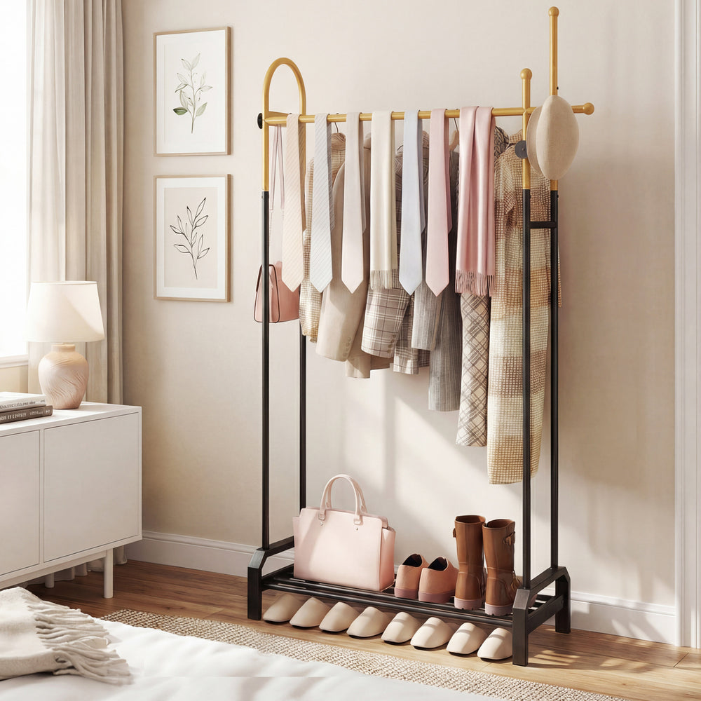 Double rods garment rack in gold and black with side hooks, bottom shelf, and modern design for stylish storage.