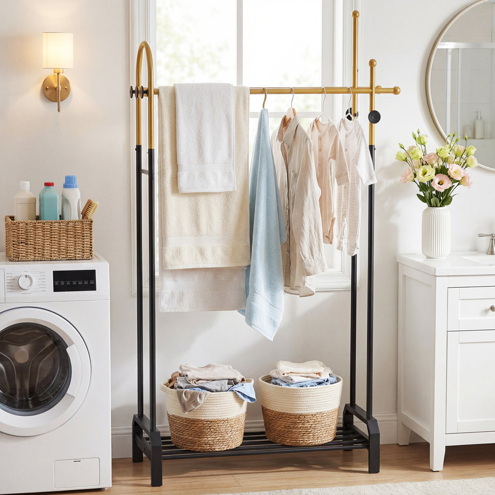 Double rods garment rack in gold and black with side hooks and bottom shelf, ideal for laundry room or entryway storage.