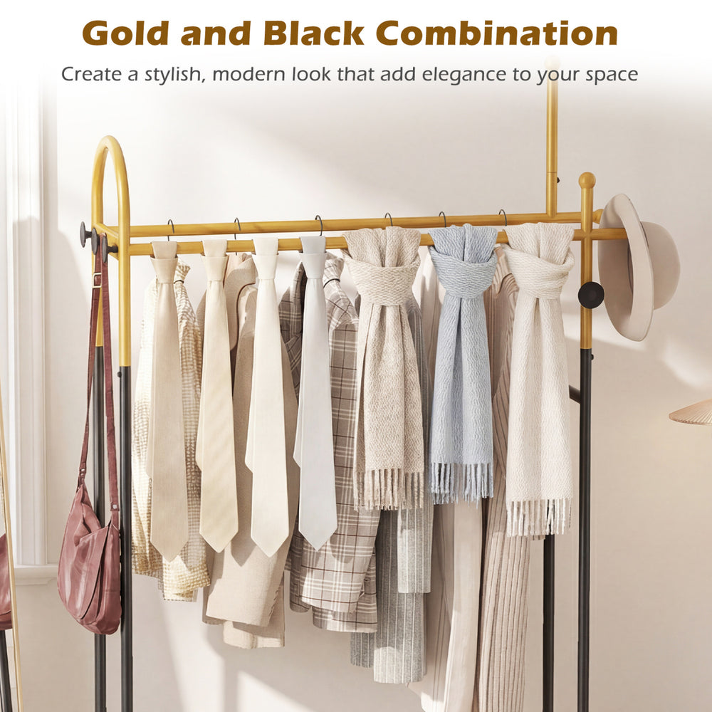 Double rods garment rack in gold and black with hanging clothes, side hooks, and bottom shelf for stylish storage.