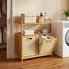 Natural bamboo double tilt-out laundry hamper with slatted design and raised side rails for secure storage and airflow.