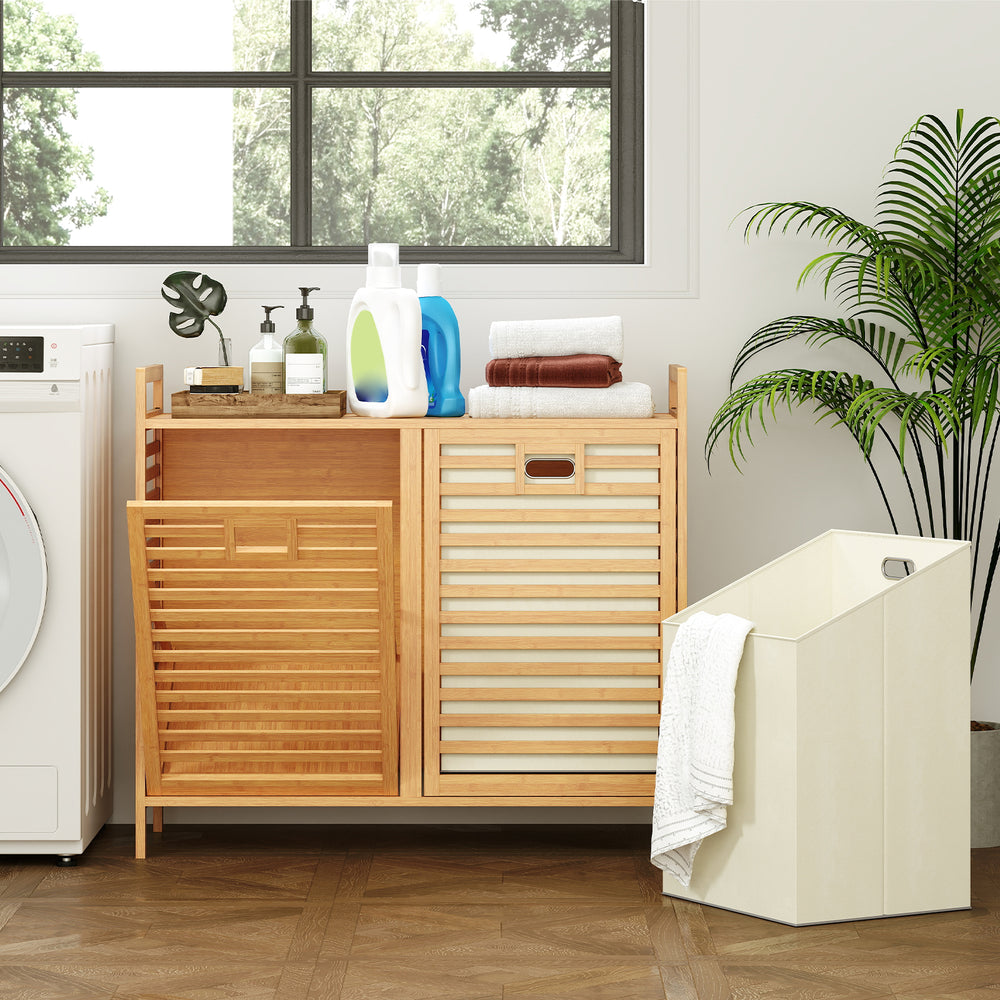 Double tilt-out laundry hamper with natural bamboo finish, featuring two removable bins and top storage shelf for.