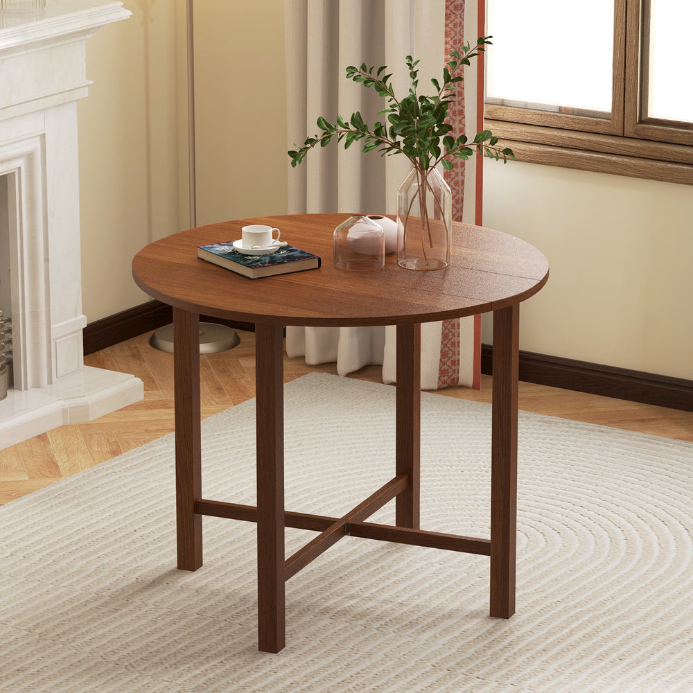 Round walnut Dual Drop Leaf Dining Table with flexible design, accommodating 2-4 people, perfect for small spaces.