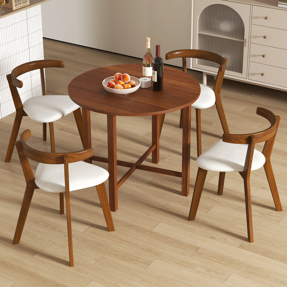 Round walnut dining table with drop leaf design, accommodating 2-4 people, perfect for small spaces and easy to clean.