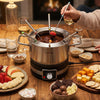 Stainless steel 1200W electric fondue pot with 6 color-coded forks, perfect for parties and easy to use.