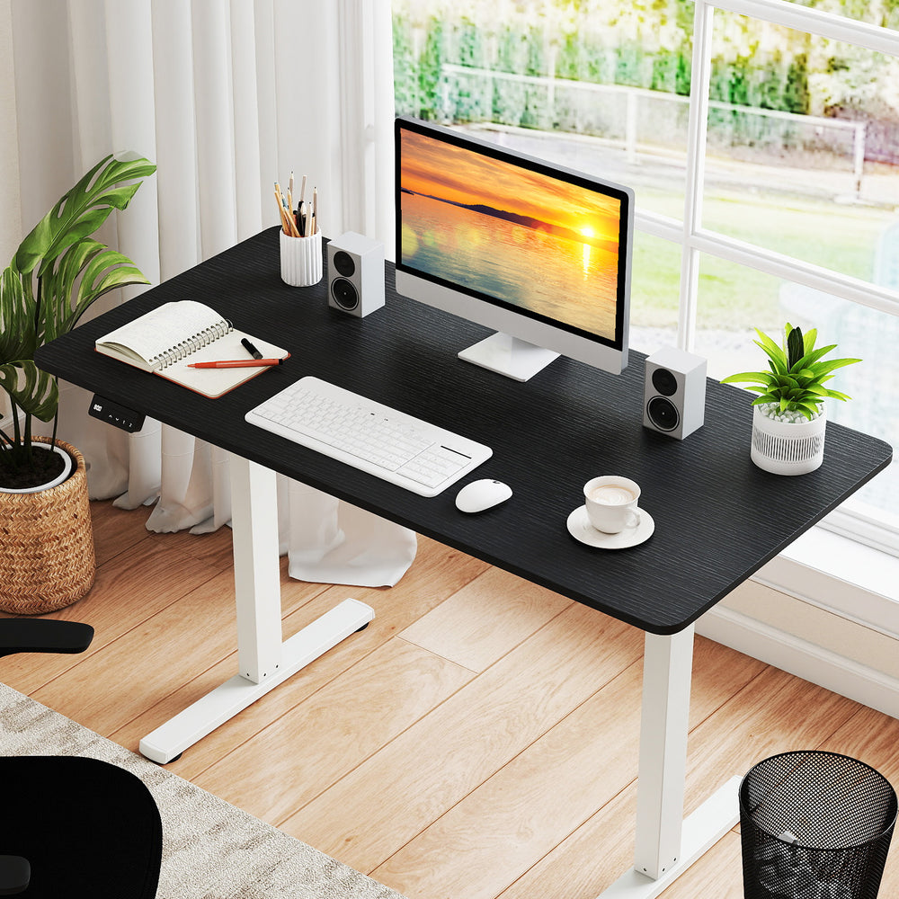 Electric standing desk with a 48" x 24" black tabletop, featuring LED display and memory height settings for versatile.