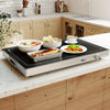 Electric warming tray with adjustable temperature, featuring a tempered glass top and built-in handles for easy.