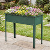 Elevated green metal raised garden bed with flowers, designed for easy planting and excellent weather resistance.