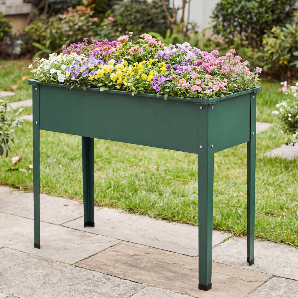 Elevated green metal raised garden bed with flowers, designed for easy planting and excellent weather resistance.