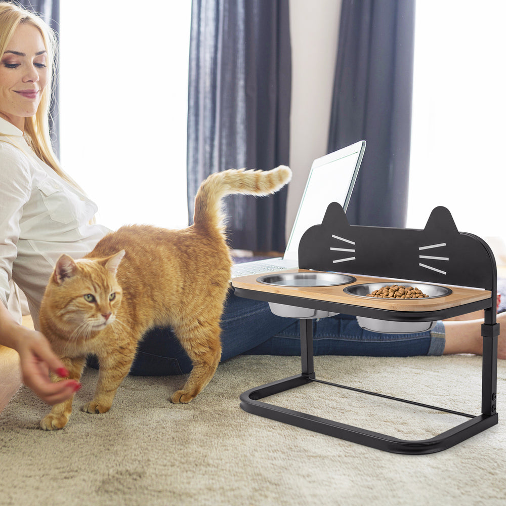 Elevated pet feeder with 2 stainless steel bowls, adjustable height, and natural bamboo design for comfortable feeding.