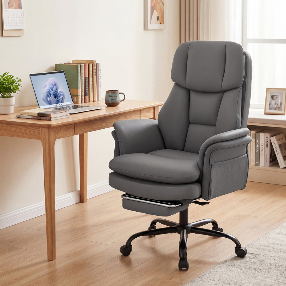 Ergonomic grey office chair with retractable footrest and adjustable armrests, perfect for cross-legged seating.